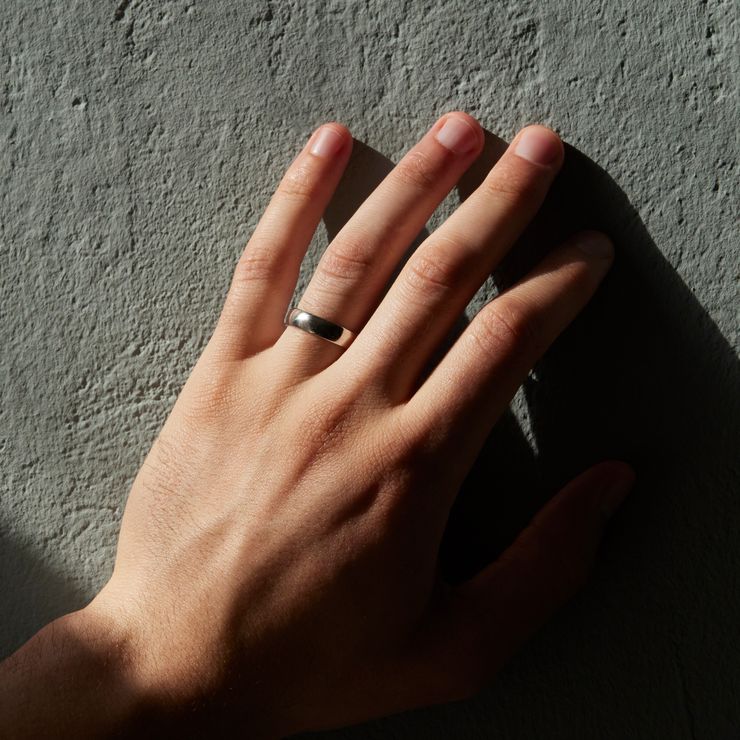 Mens polished wedding ring band on hand