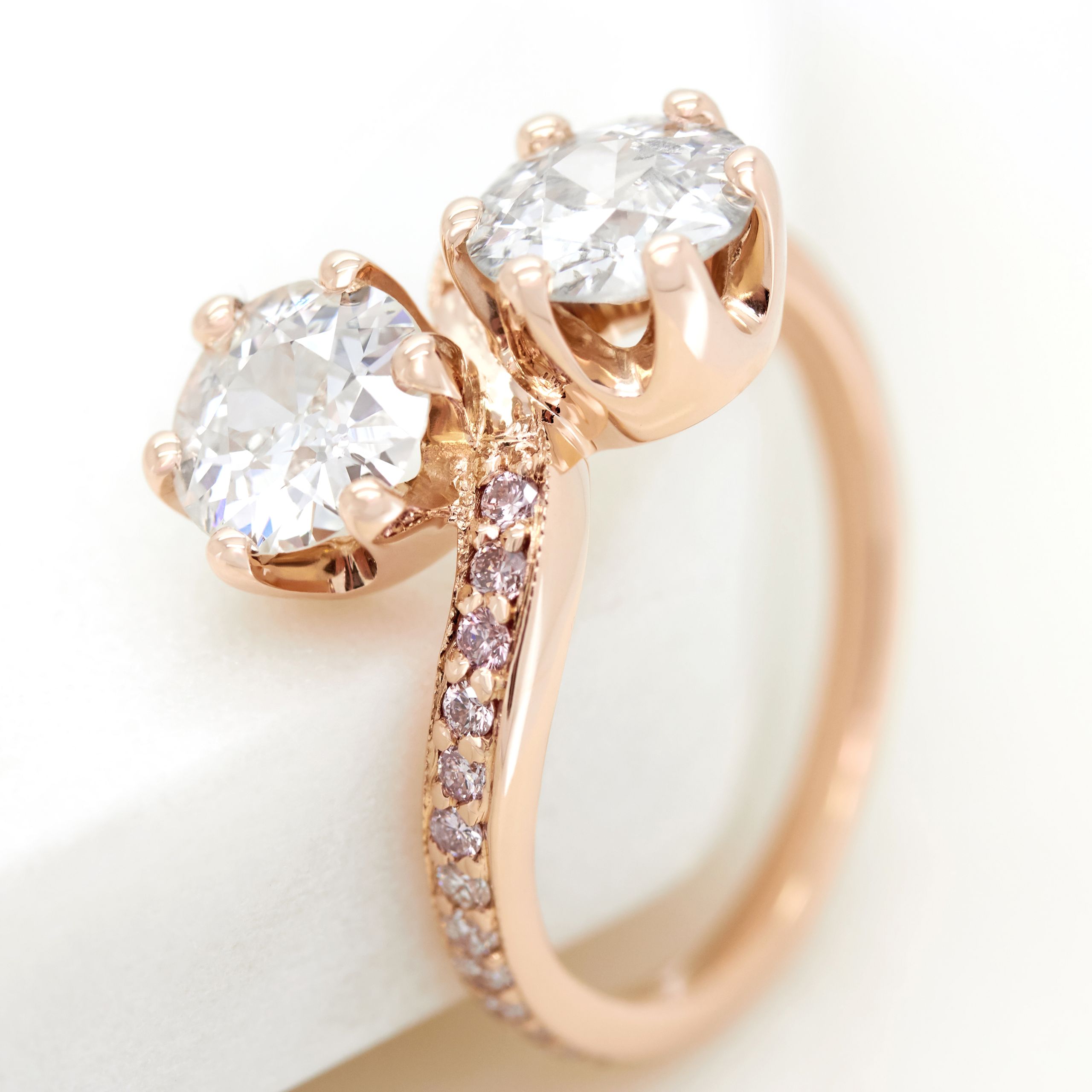 Old european diamonds in a crown setting engagement ring with pave pink diamond band