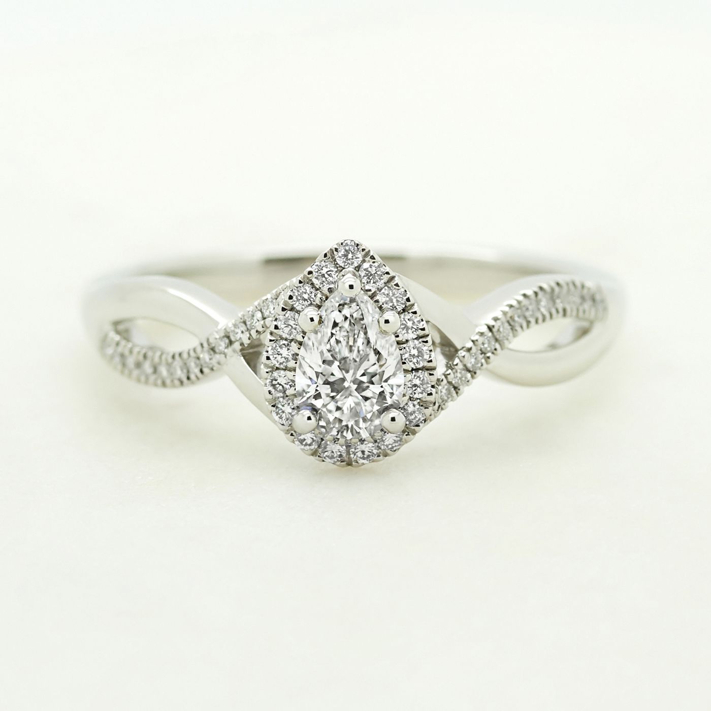 Pear diamond with pave twisted band