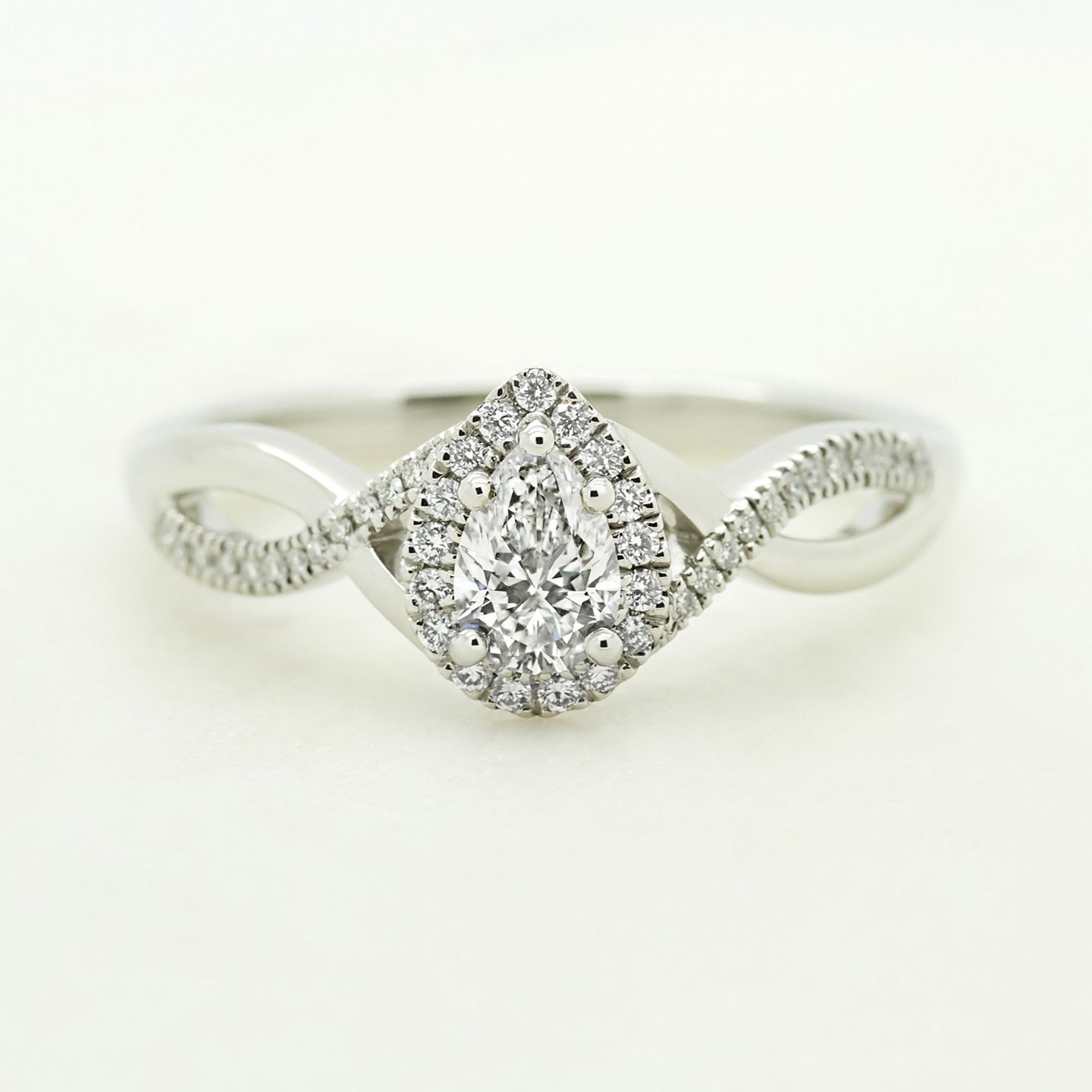 Pear diamond with pave twisted band