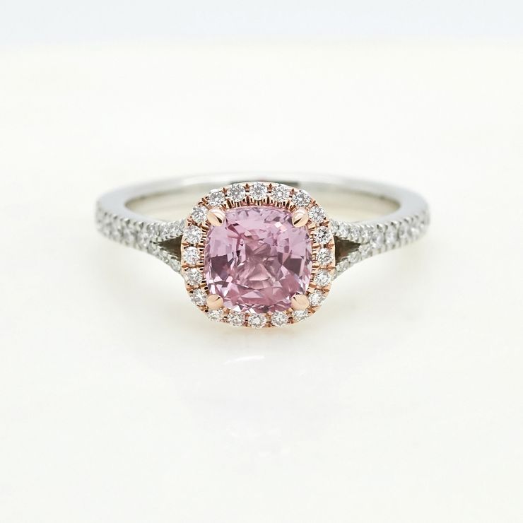Cushion cut pink sapphire set in platinum with diamond pave