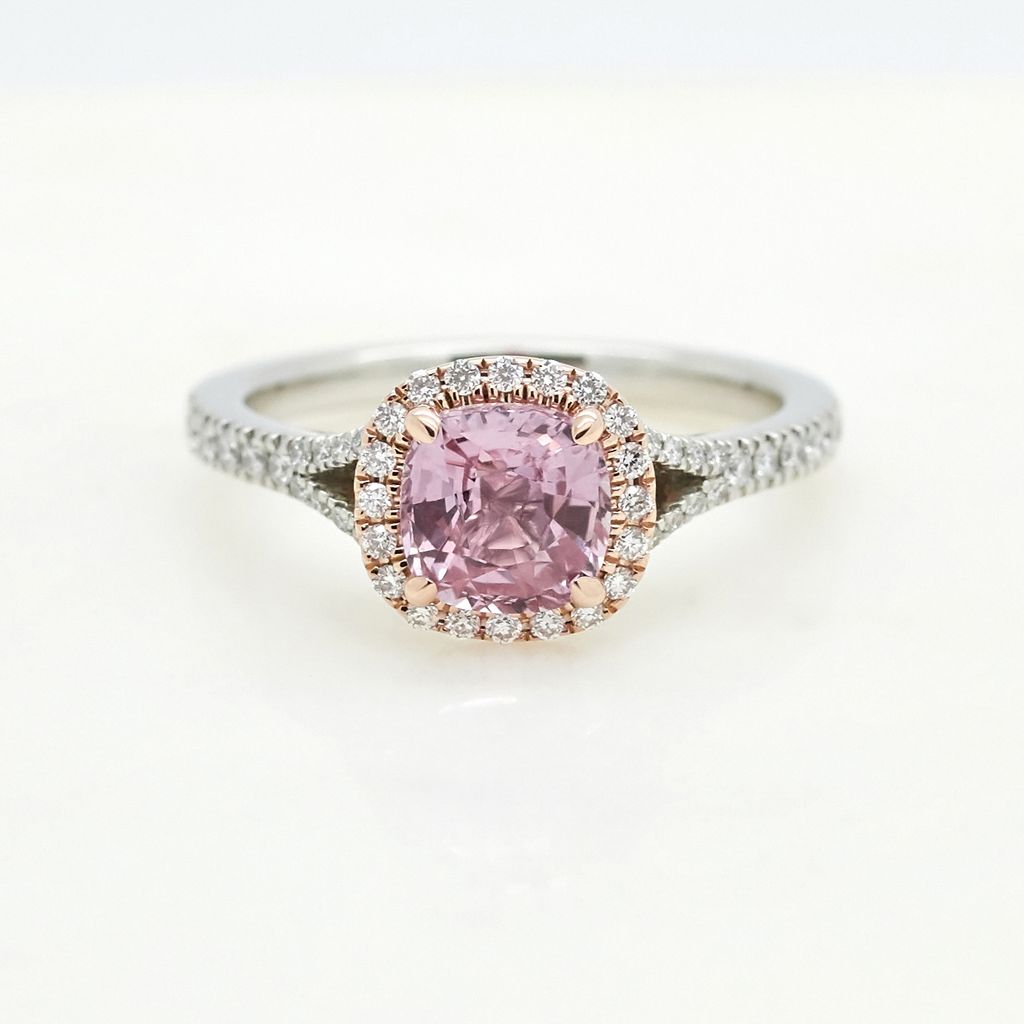 Cushion cut pink sapphire set in platinum with diamond pave