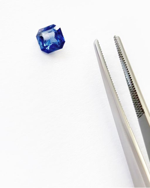 Asscher blue sapphire loose with tweezers