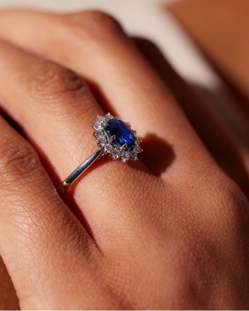 Lyra blue sapphire oval centre with diamond halo engagement ring
