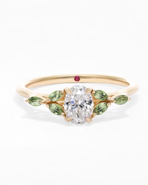 Oval diamond Tamora engagement ring in yellow gold with light green marquise sapphires