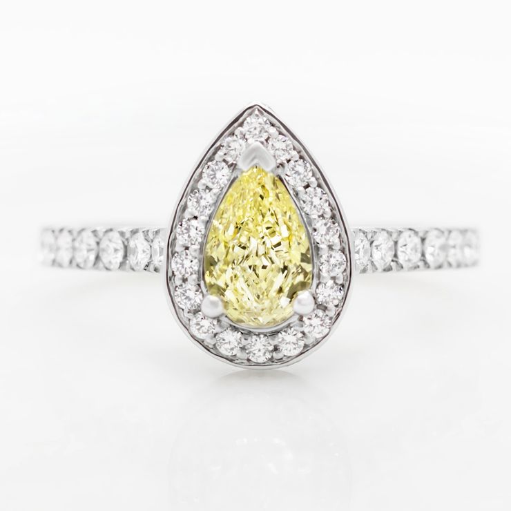 Fancy yellow pear shape diamond with diamond halo engagement ring