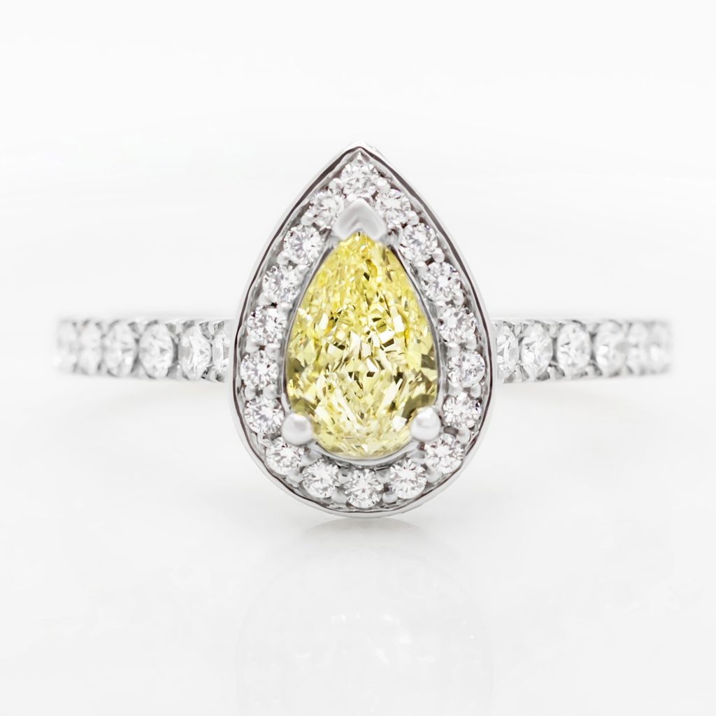 Fancy yellow pear shape diamond with diamond halo engagement ring