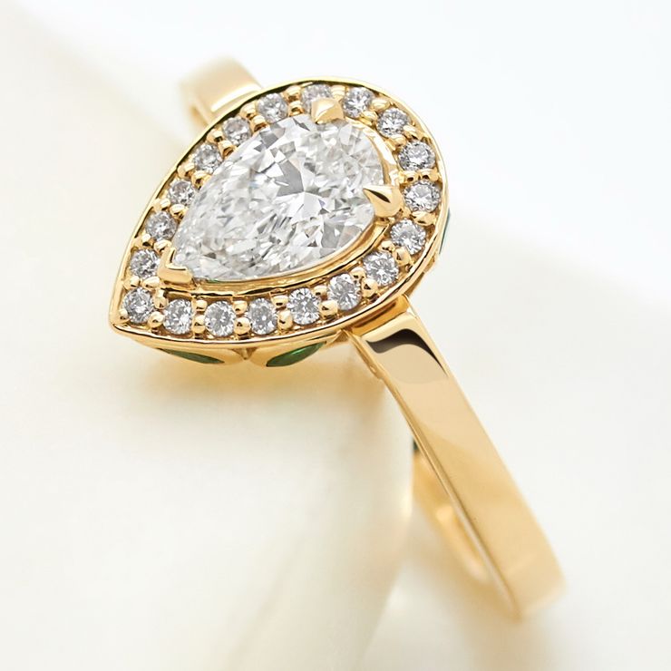 Pear diamond pave yellow gold emerald basket engagement ring