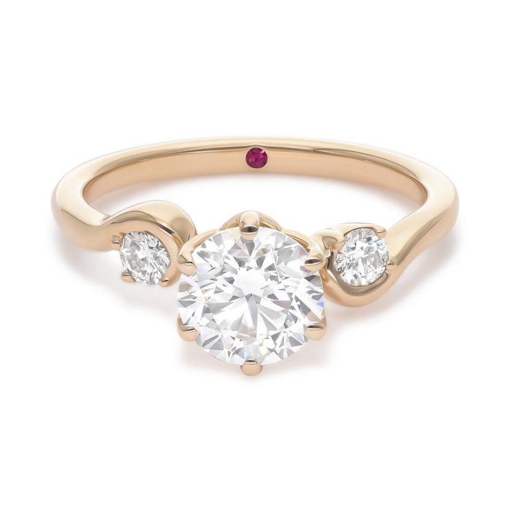 Asymmetric yellow gold engagement ring with round diamond centre and half bezel round accent stones