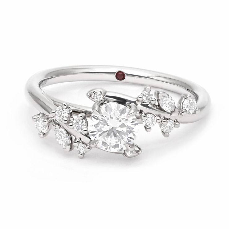 Organic nature inspired platinum engagement ring with round centre diamond and round and marquise cluster accent stones