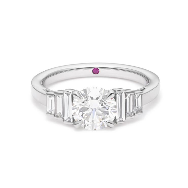 Custom round diamond platinum engagement ring with descending straight baguette side stones