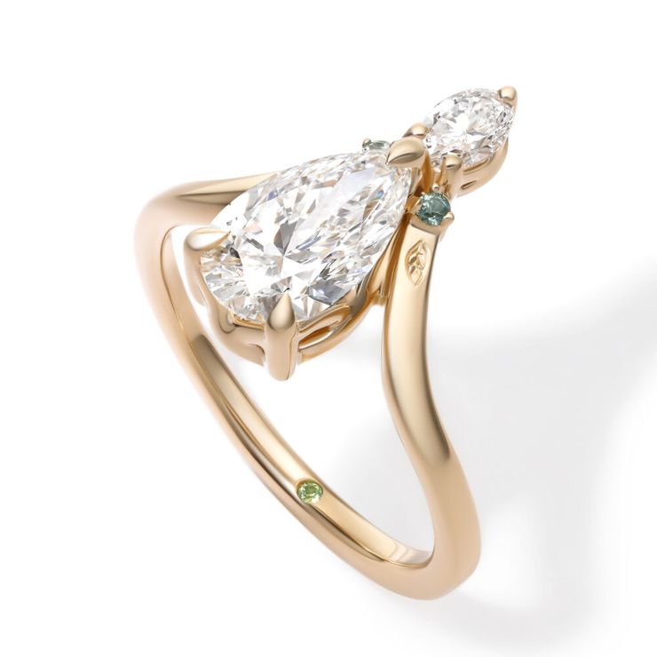 Yellow gold pear diamond engagement ring with engraved leaves and light green sapphire accents