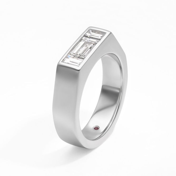 East West emerald diamond with diamond baguettes set in a chunky platinum band