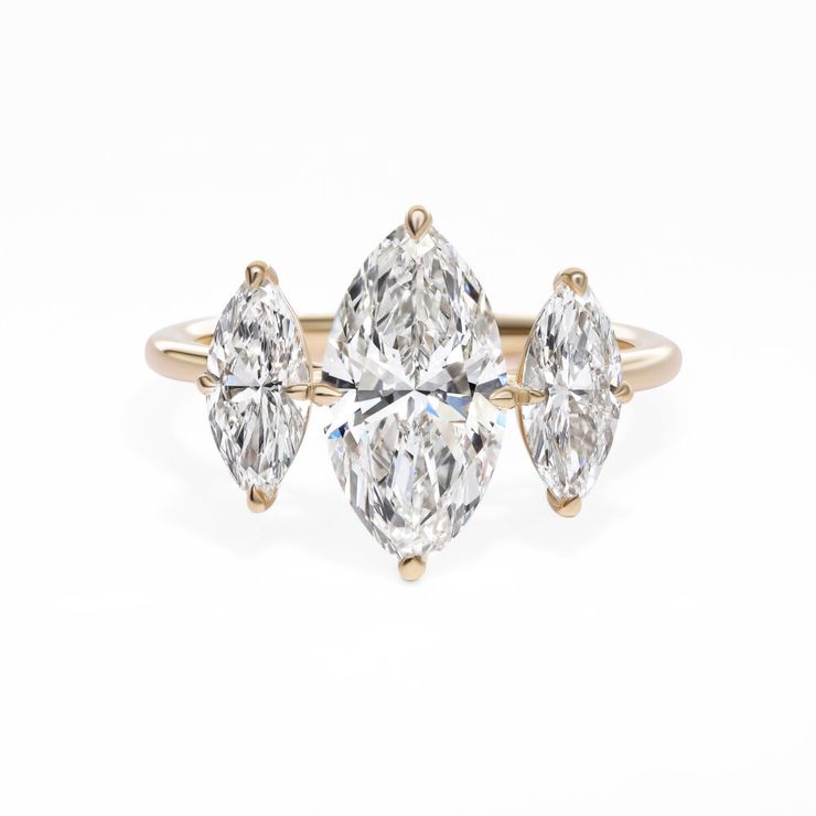 Marquise diamond trilogy three stone engagement ring crafted in yellow gold