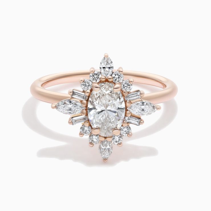 Oval diamond engagement ring with tapered baguette and round diamond fanned halo set in rose gold