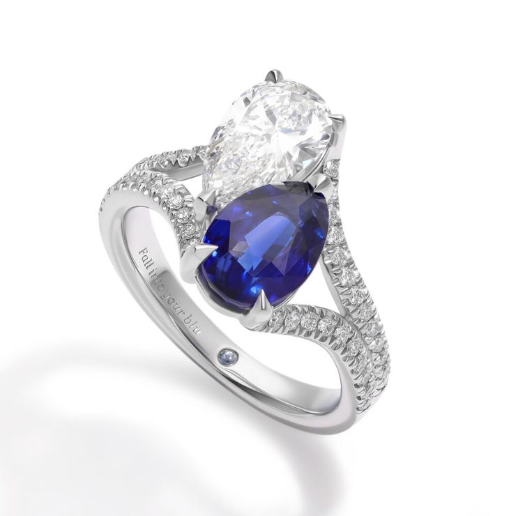 Custom toi et moi platinum engagement ring with pear diamond and blue sapphire with split shank diamond pavé band