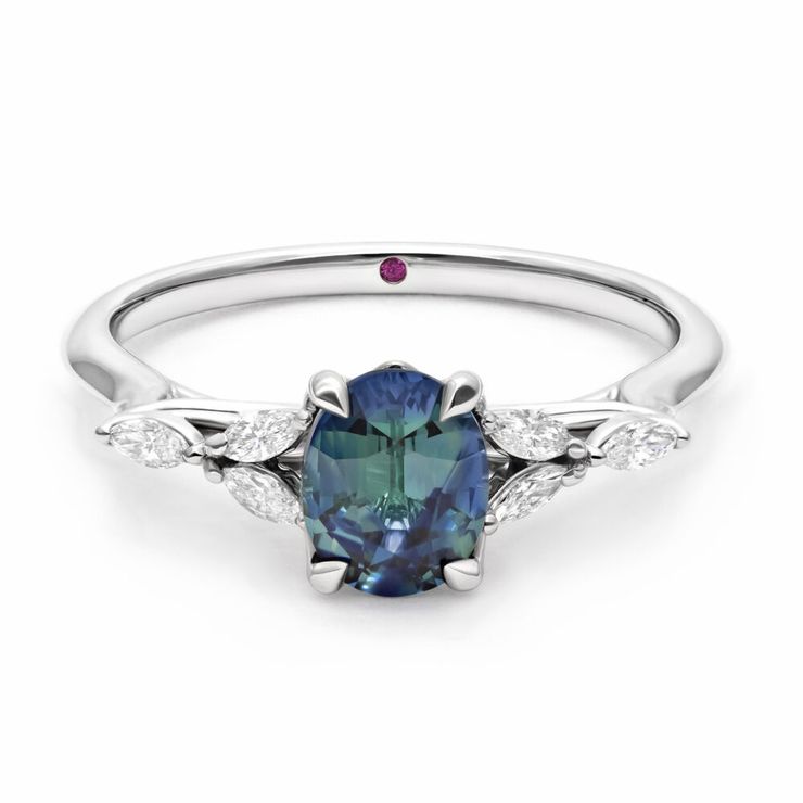 Customised Tamora design with a blue-green oval sapphire set in platinum with diamond marquise side accent stones