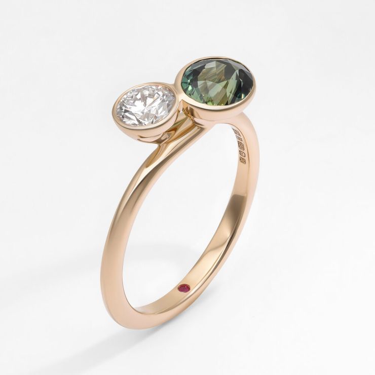Round diamond and dark green sapphire toi et moi bezel set yellow gold engagement ring