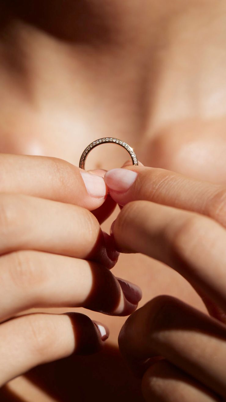 Knife edge diamond pave wedding ring in hand