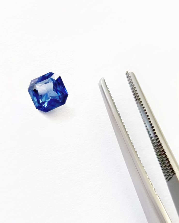 Asscher blue sapphire loose with tweezers