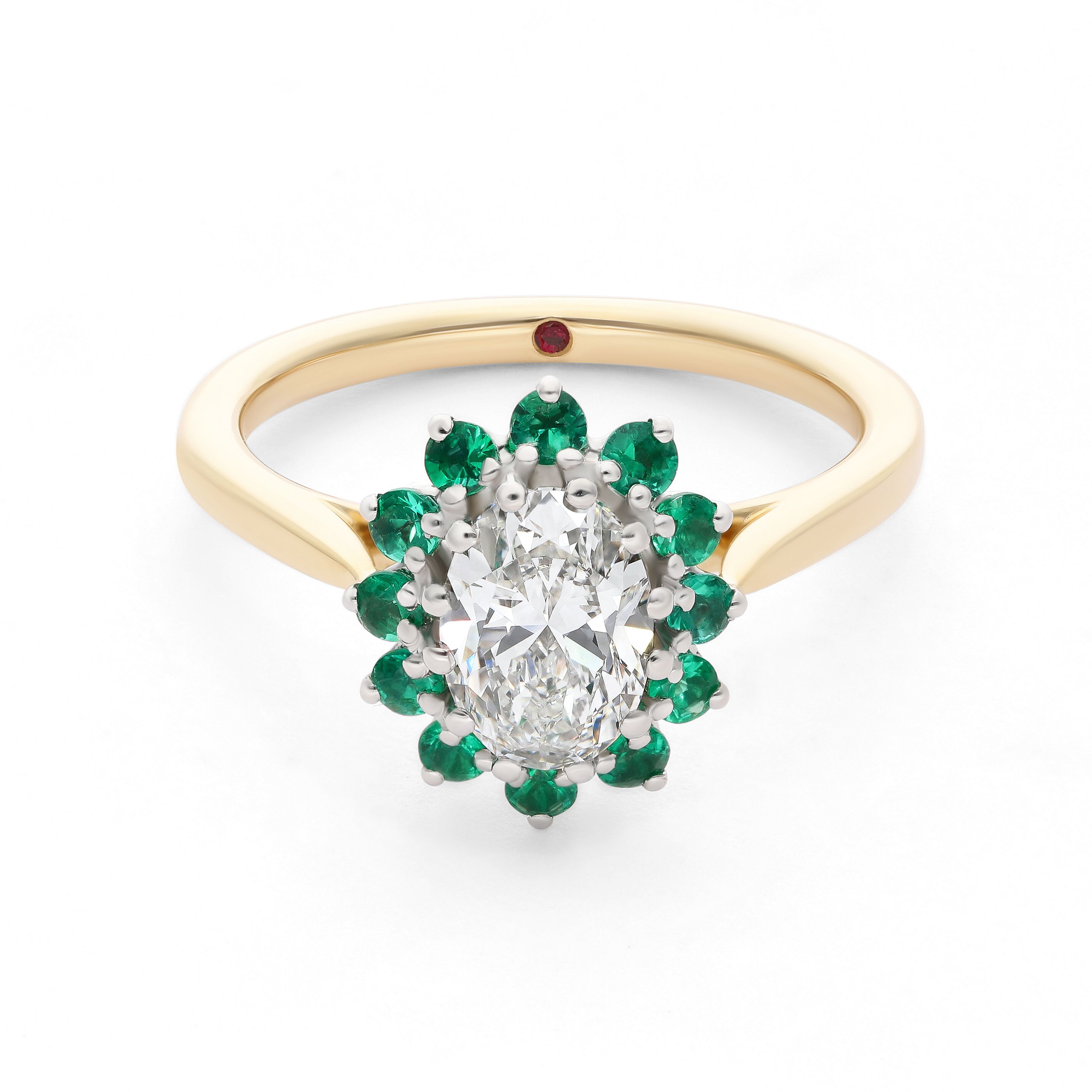Emerald cut emerald with a round diamond halo set in yellow gold