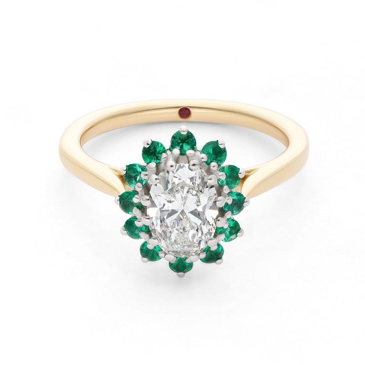 Emerald cut emerald with a round diamond halo set in yellow gold