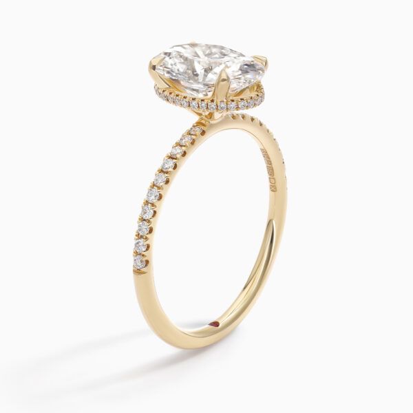 Oval diamond hidden halo engagement ring yellow gold