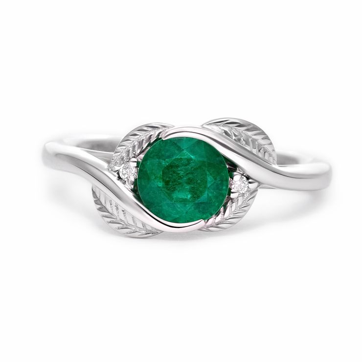 Round emerald engagement ring with leaf inspired engraved metalwork
