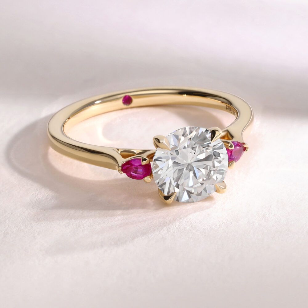 Yellow gold oval diamond faith engagement ring with pink pear sapphire side stones trilogy square