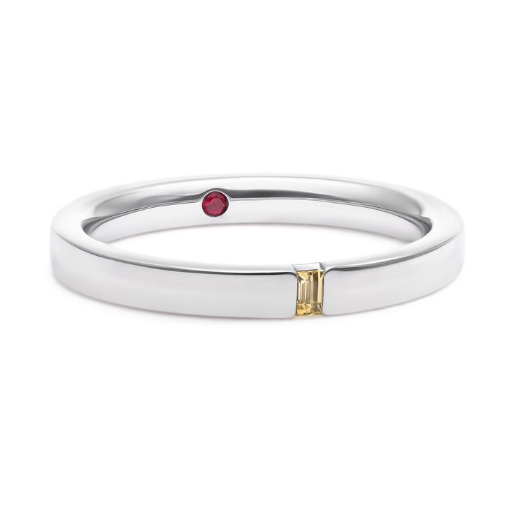 Narrow platinum polished band with yellow sapphire baguette