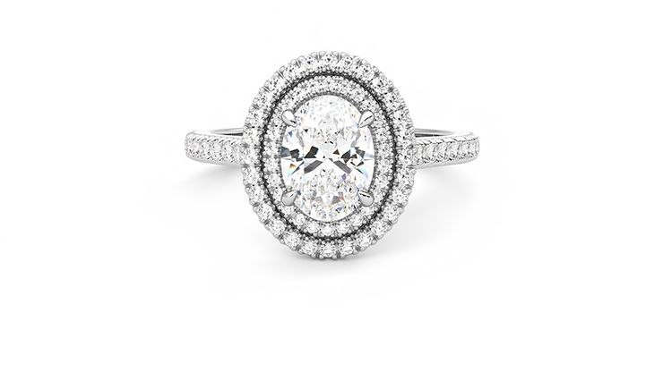 Oval centre and pavé diamond double halo engagement ring set in platinum