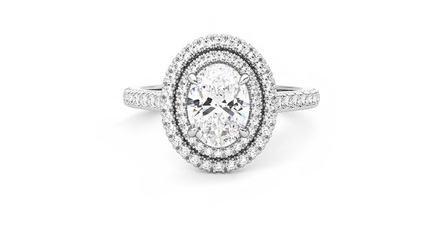 Oval centre and pavé diamond double halo engagement ring set in platinum