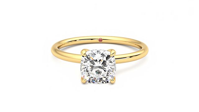Cushion diamond solitaire engagement ring set in 18ct yellow gold
