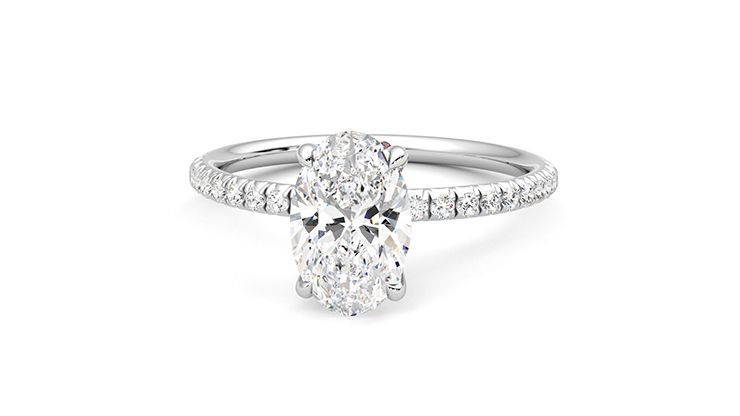 Oval diamond centre and fishtail pavé diamond band engagement ring set in platinum