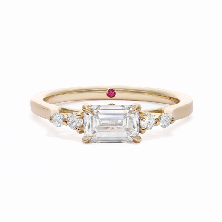 East west emerald diamond with round accent diamonds yellow gold