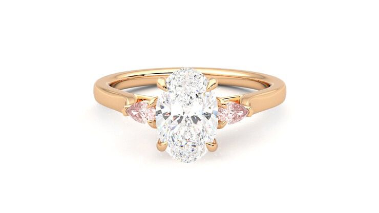 Trilogy engagement ring with oval centre diamond and peach sapphire sides