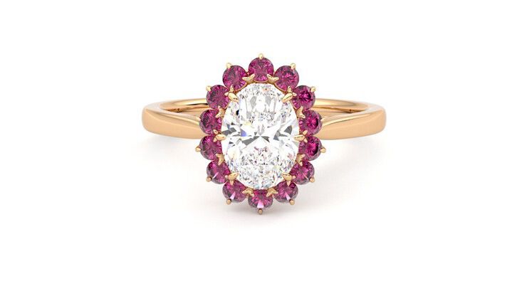 Oval solitaire engagement ring with floral pink sapphire halo