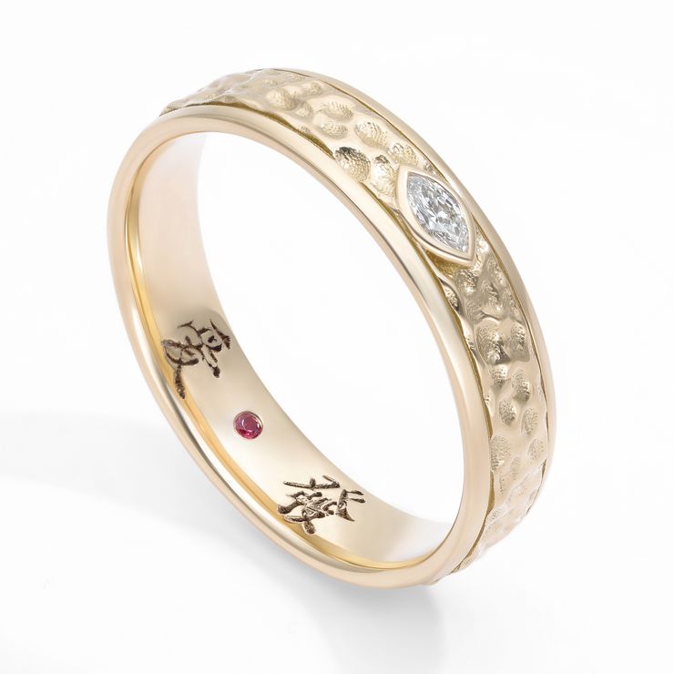 Yellow gold hammered finish band with east-west set marquise diamond