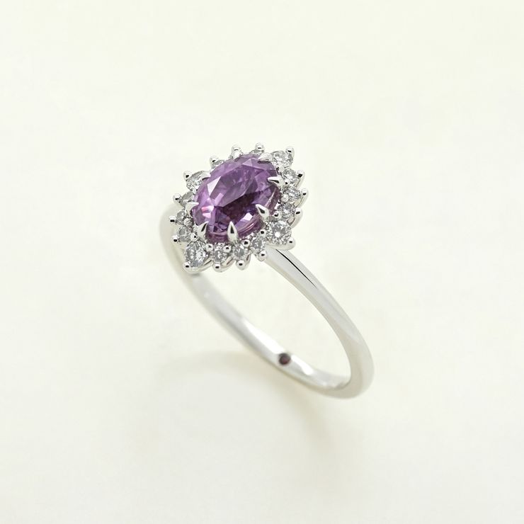 Purple oval sapphire set in platinum with diamond pave