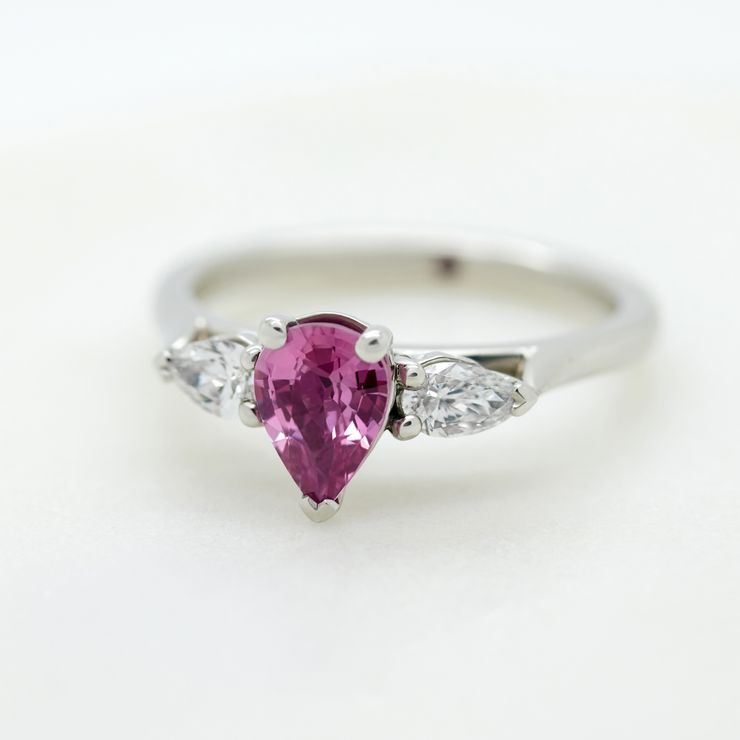 Pear shaped grape purple sapphire with pear shaped side diamonds set in platinum