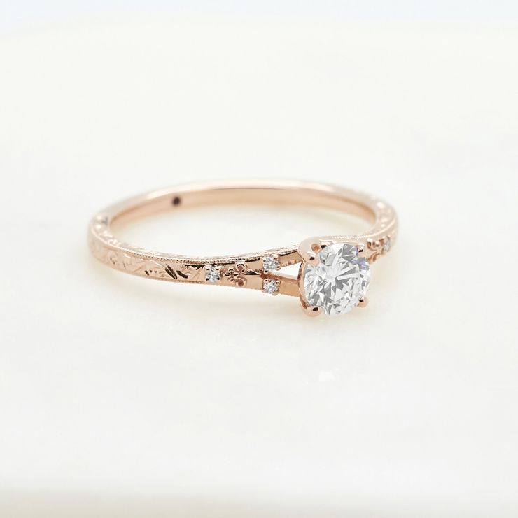 Rose gold dainty engagement ring with a round diamond and engraving