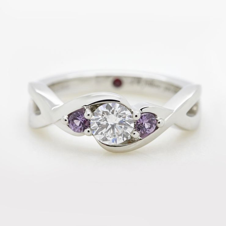 Round brilliant diamond set with round purple sapphires set in platinum