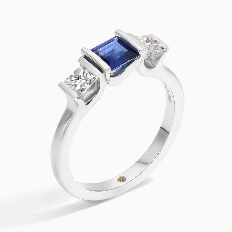 Unisex trilogy engagement ring with tension set princess cut blue sapphire and diamonds