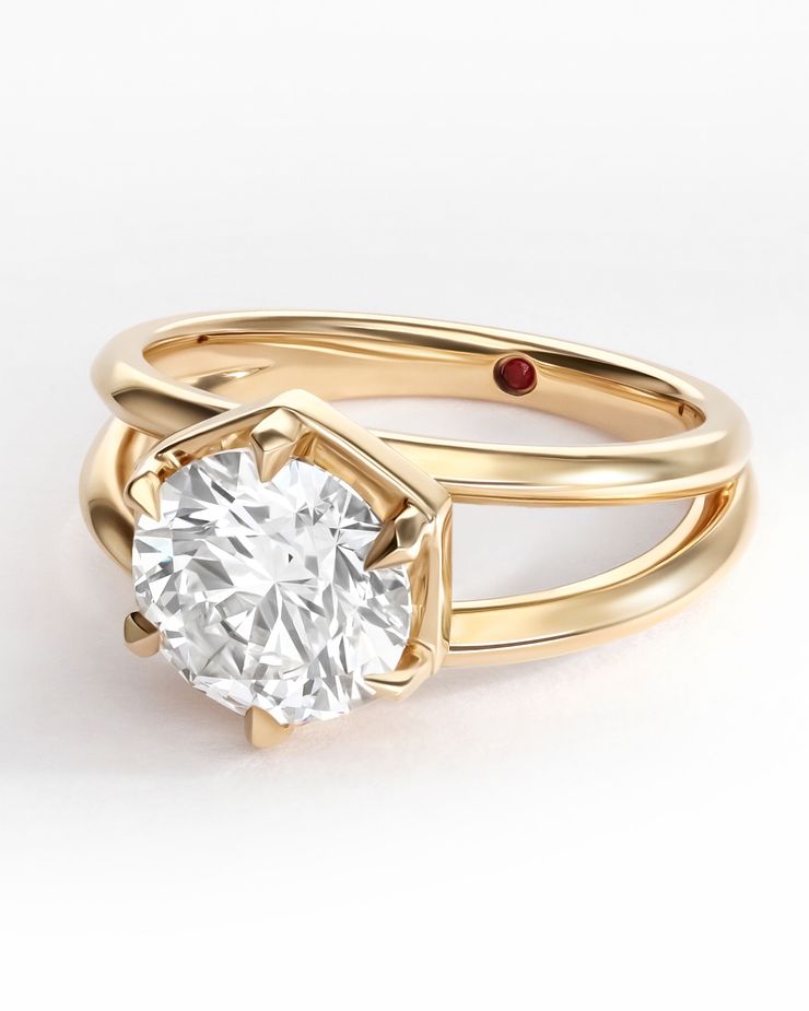 Wide split shank yellow gold engagemnet ring with round diamond and hexagonal basket detail