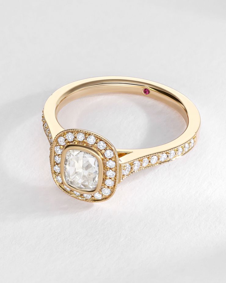 Bezel yellow gold rose cut diamond engagement ring with a bezel set halo