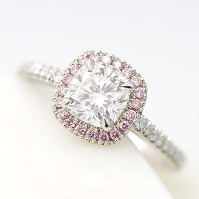 Cushion cut diamond with pink diamond halo