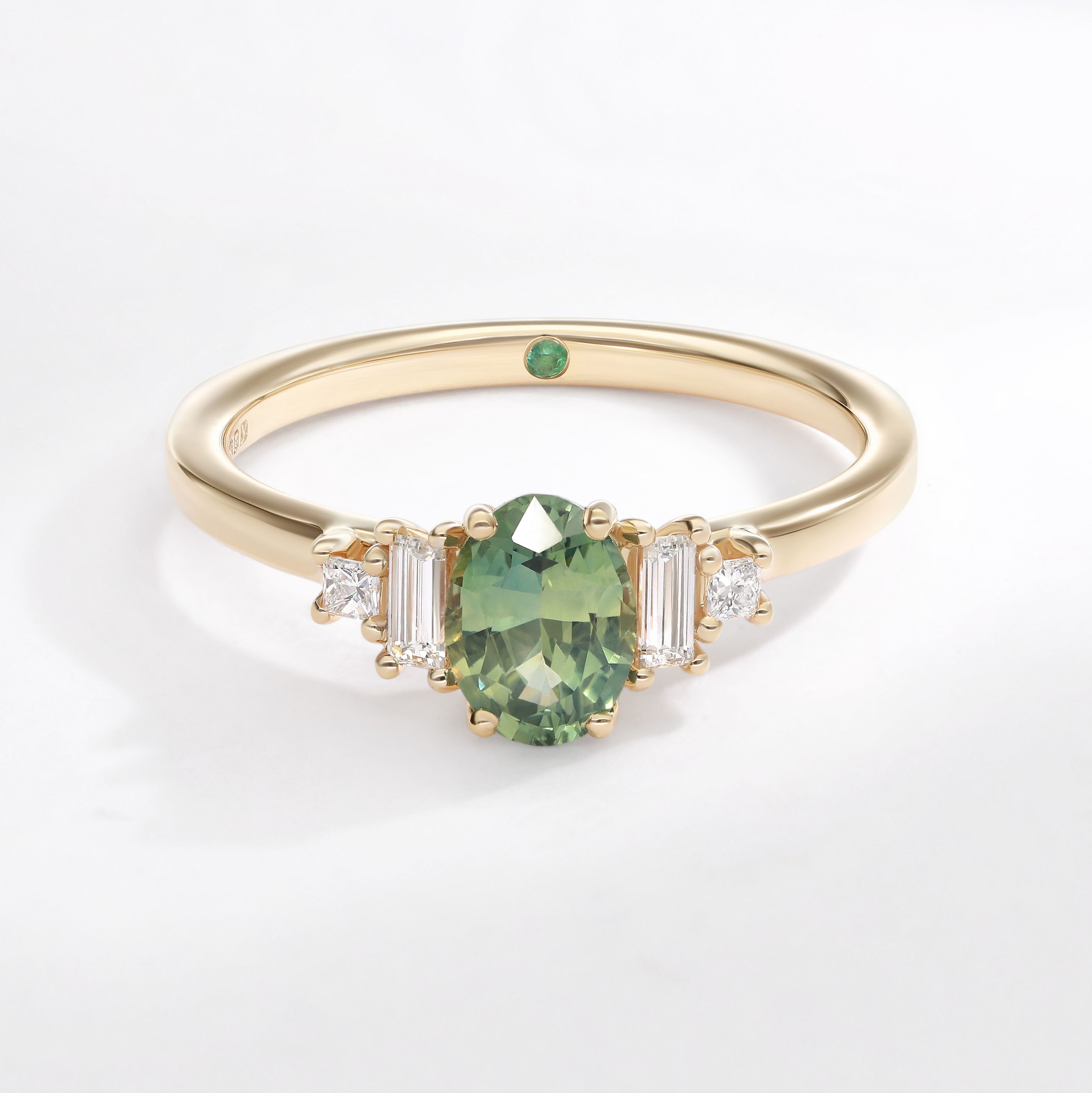 Five stone yellow gold green oval sapphire engagement ring with baguette and princess accent diamonds