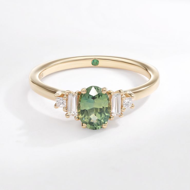 Five stone yellow gold green oval sapphire engagement ring with baguette and princess accent diamonds