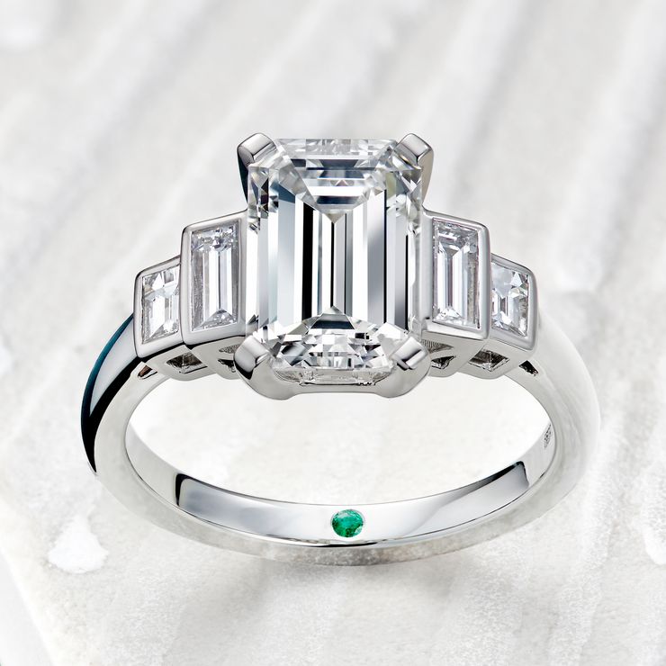 Emerald cut diamond engagement ring with diamong baguette side stones