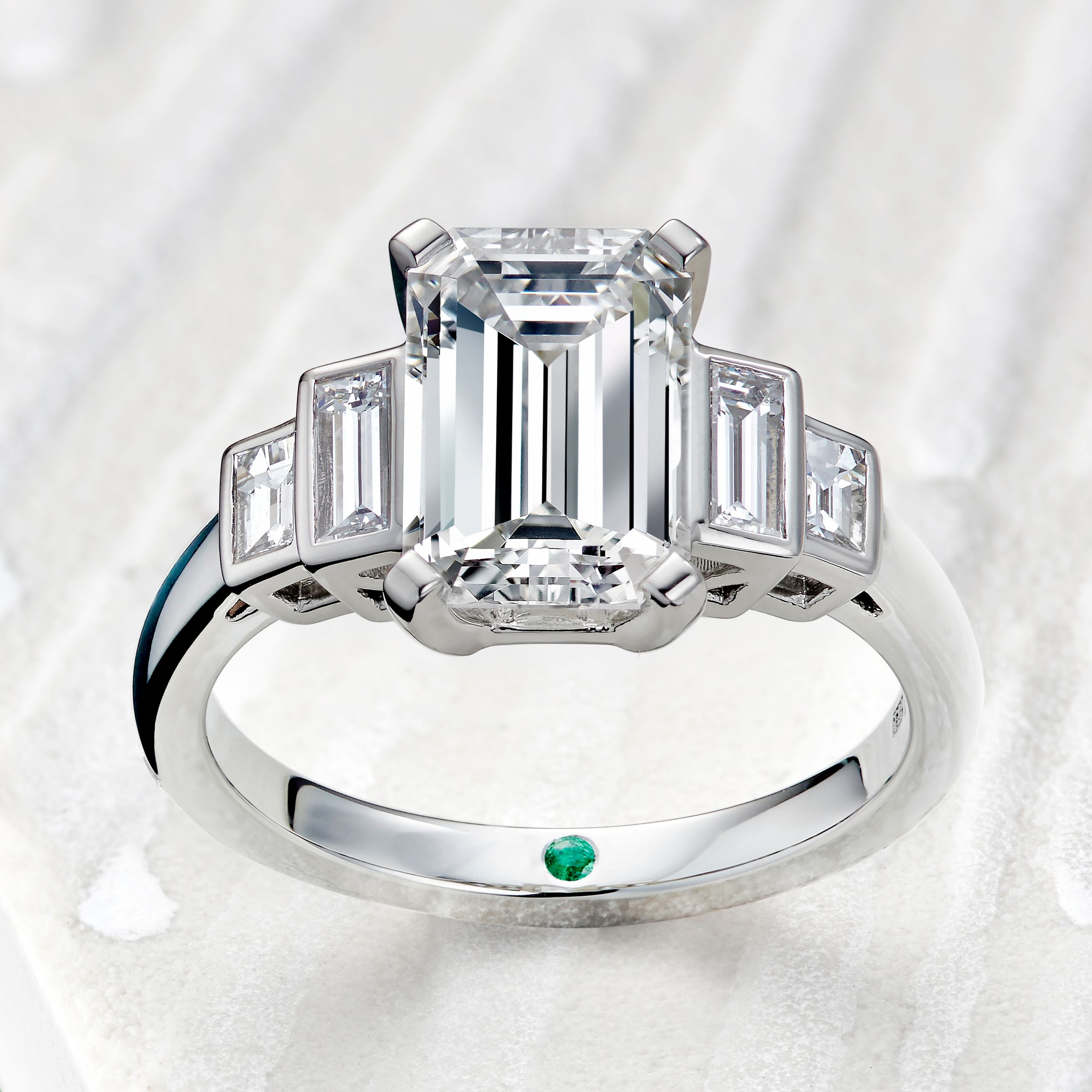 Emerald cut diamond engagement ring with diamong baguette side stones